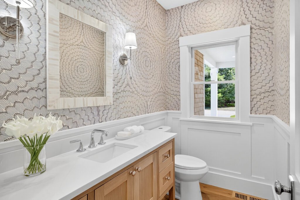 Powder room with oak vanity and marble countertop